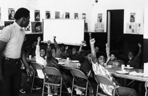 20 Dec 1969, San Francisco, California, USA --- A teacher leads his students with the black power salute and slogans at a Black Panther liberation school. --- Image by © Bettmann/CORBIS