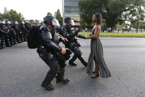 A demonstrator protesting the shooting death of Alton Sterling is detained by law enforcement near the headquarters of the Baton Rouge Police Department in Baton Rouge, Louisiana, U.S. July 9, 2016. REUTERS/Jonathan Bachman TPX IMAGES OF THE DAY - RTSH3XR